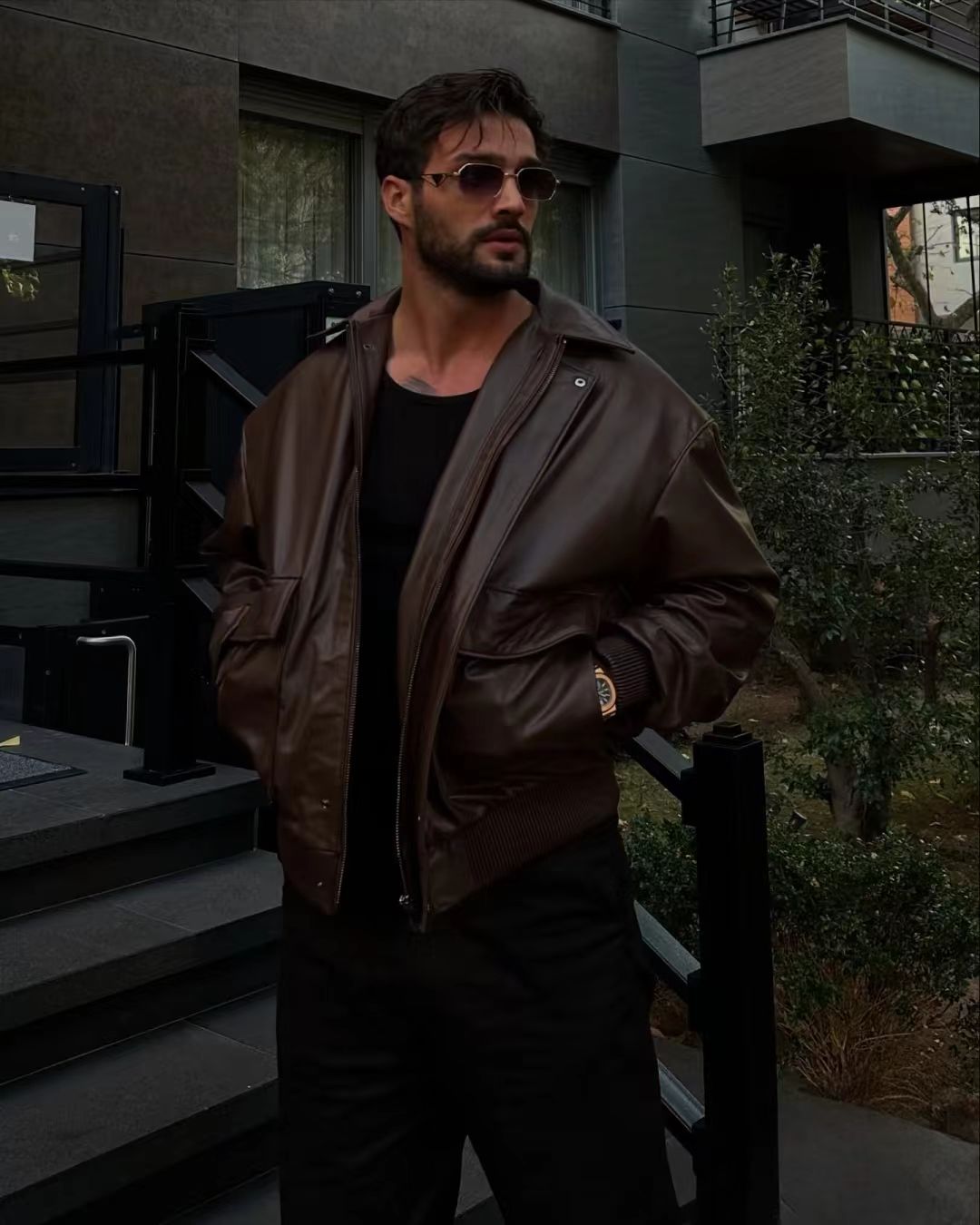 Urban Toughness: Brown Leather Jacket and Monochrome Swagger